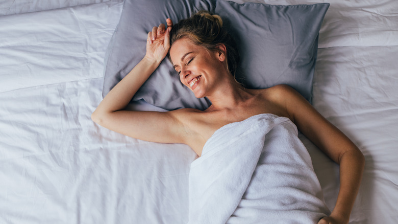 Woman sleeping on clean sheets