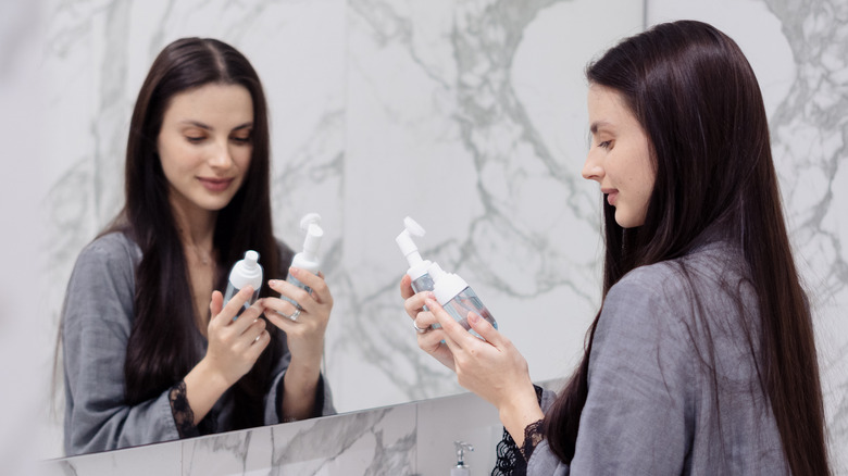 Woman picking between two products 