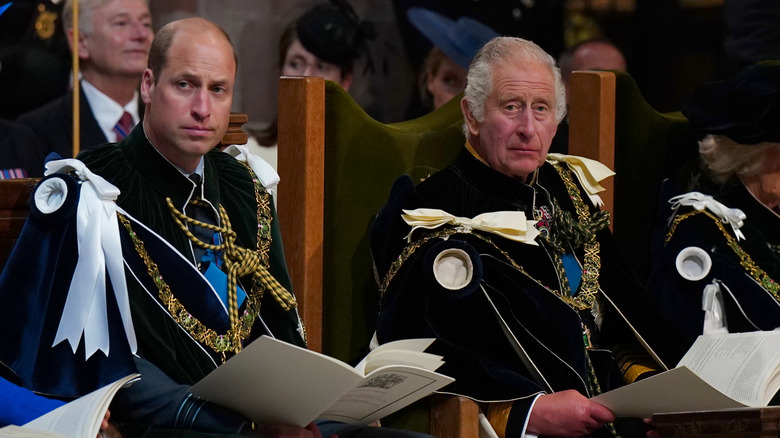 King Charles sitting with Prince William