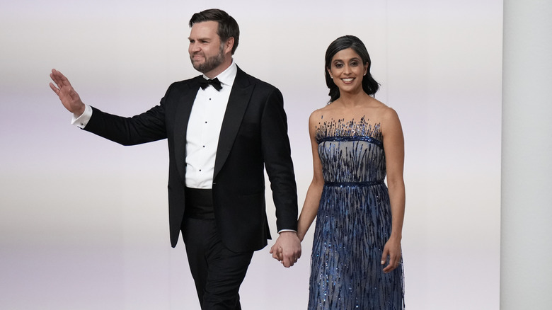 JD Vance waving at the crowd while holding Usha Vance's hand