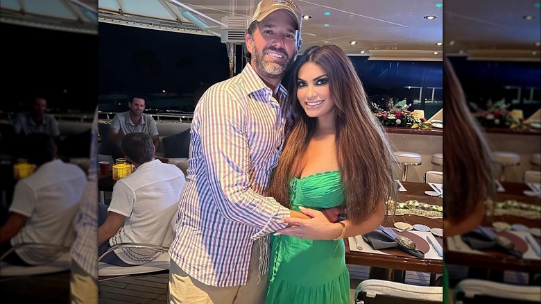 Donald Trump Jr. holding Kimberly Guilfoyle green dress