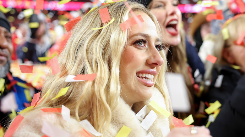 Brittany Mahomes smiling as confetti falls from the air