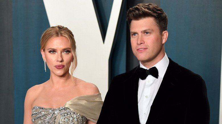 Scarlett Johansson purses her lips next to Colin Jost