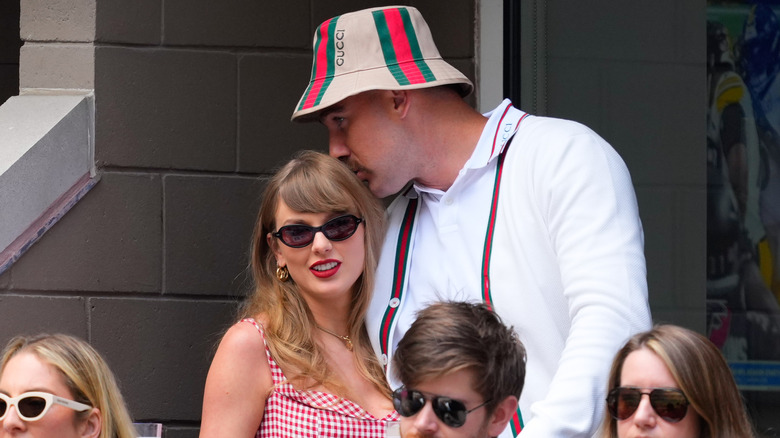 Travis Kelce kissing Taylor Swift on the head