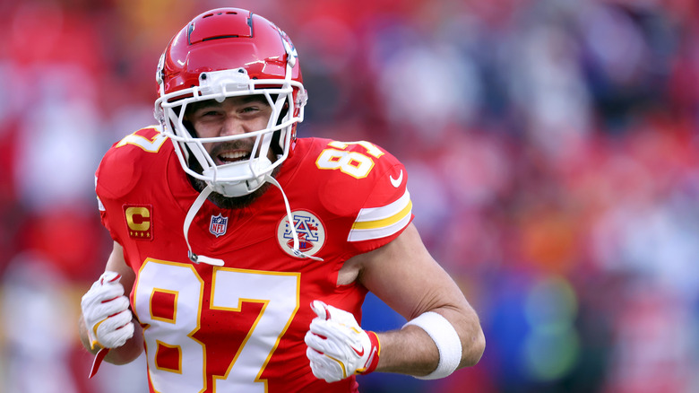 Travis Kelce smiling in football gear