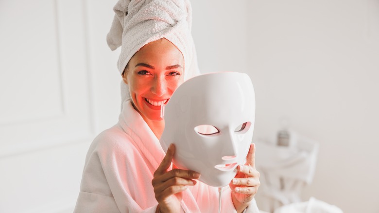 Woman using LED mask for skincare