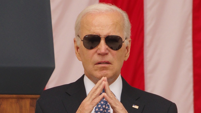 Joe Biden in aviators hands up