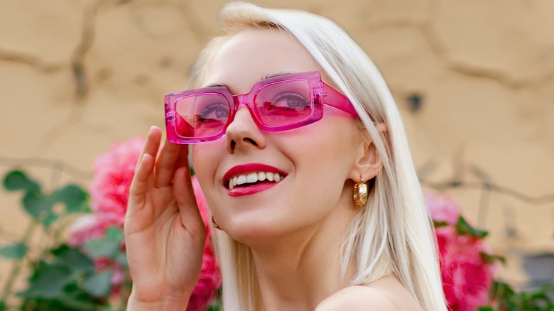 woman wearing pink tinted sunglasses