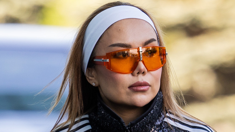 woman wearing orange tinted sunglasses