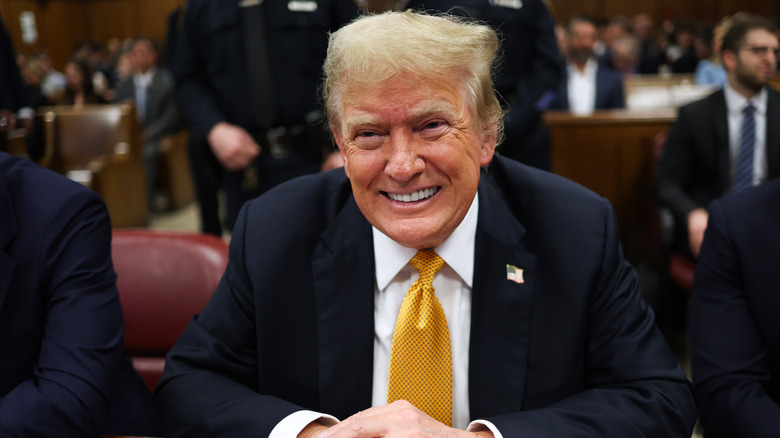 Donald Trump grinning in court