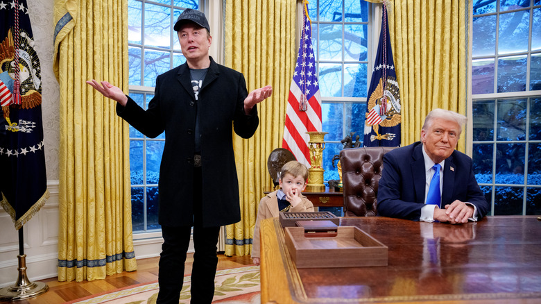 Elon Musk talking while Donald Trump sits