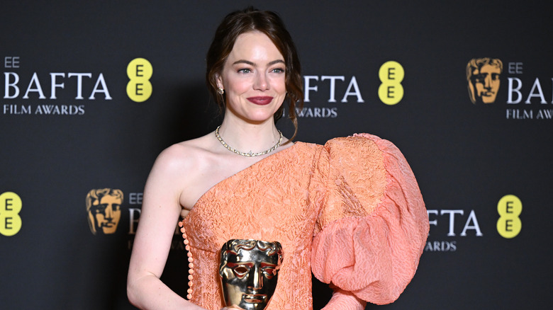 Emma Stone smiling with BAFTA award