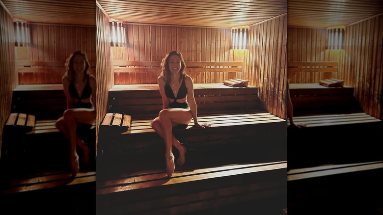 Autumn Reeser smiling in a wooden sauna 