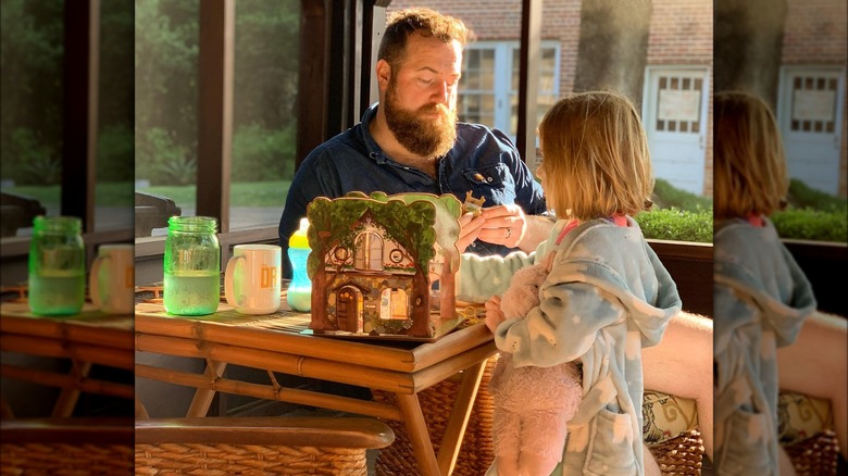 Ben Napier assembling a dollhouse with daughter