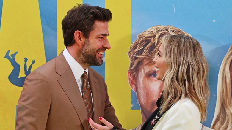 John Krasinski smiling at Emily Blunt on 'The Fall Guy' red carpet