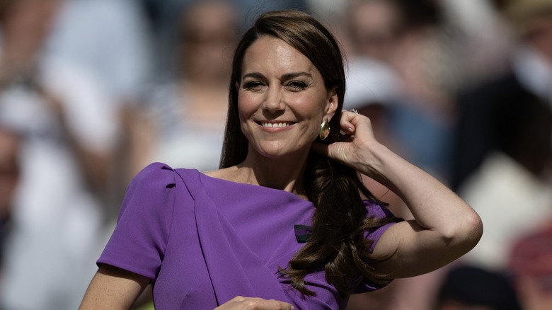 Kate Middleton smiling, adjusting hair