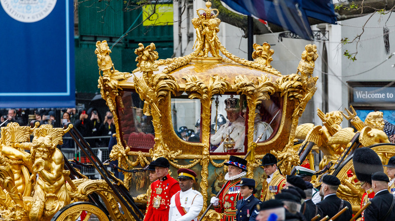 King Charles and Queen Camilla in golden stage coach