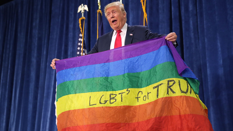 Donald Trump holding rainbow flag