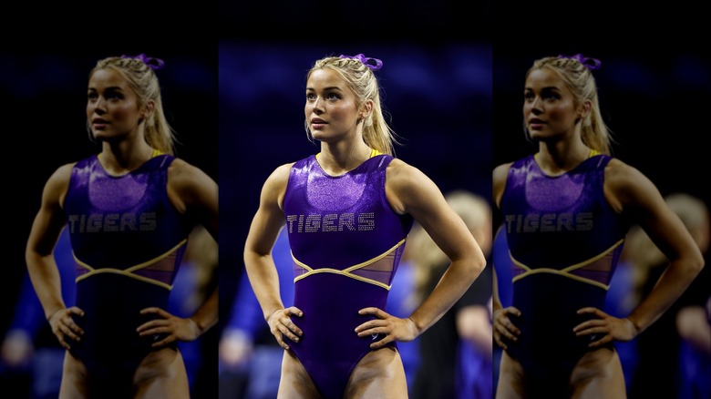 Olivia Dunne in purple leotard with hands on her hips