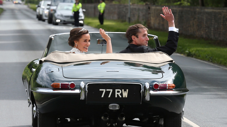 Pippa Middleton and James Matthews ride off in a car at their wedding