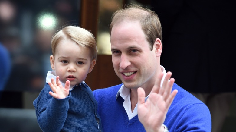 Prince William holding Prince George