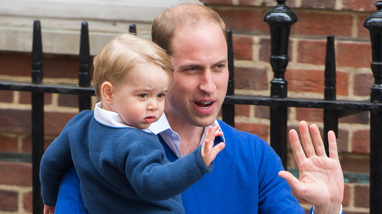 Prince William holding Prince George