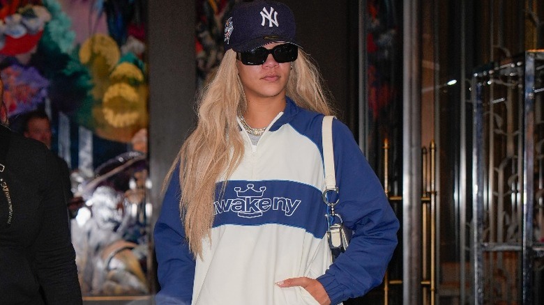 Rihanna in blonde hair and a baseball cap