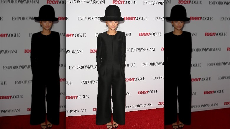 Zendaya wearing a giant bowler hat and black jumpsuit