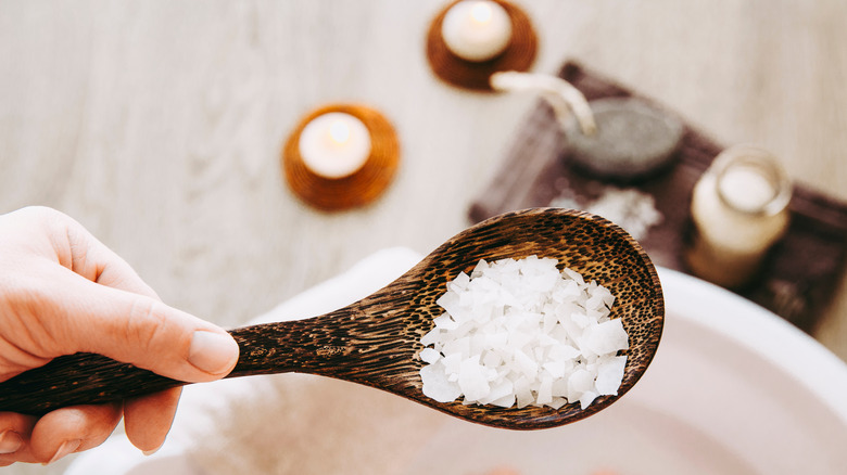 scoop of salt over bathtub