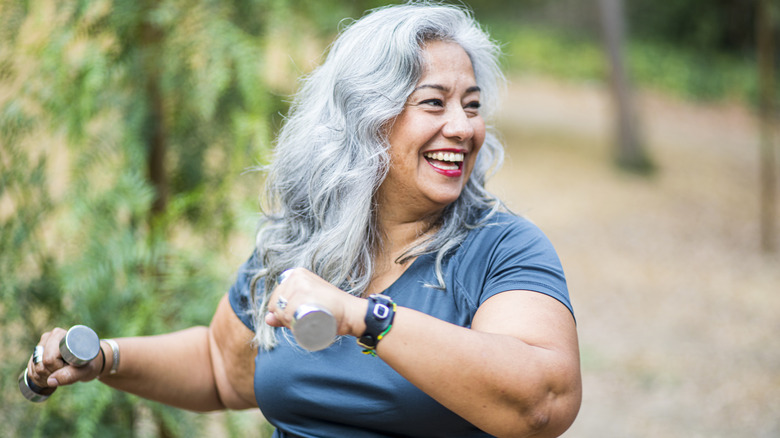 smiling woman exercising outside