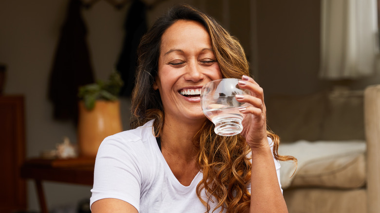 smiling woman drinking water