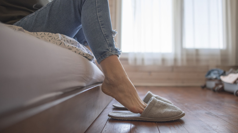 Putting feet in slippers