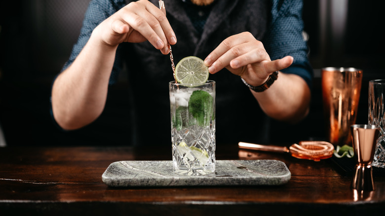 Bartender preparing a gin and tonic