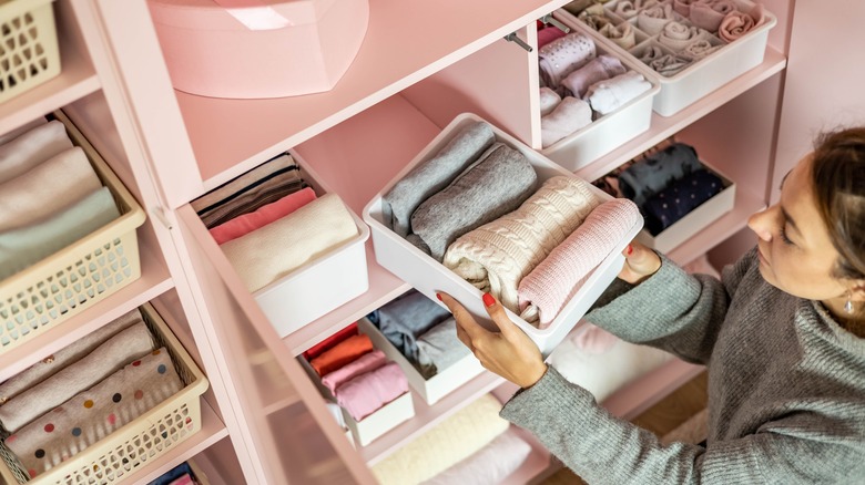 Woman tidying out wardrobe