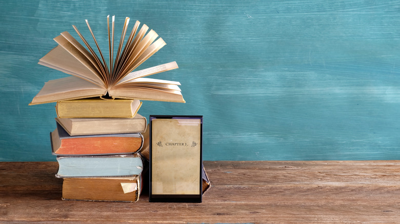 A stack of books and an eReader