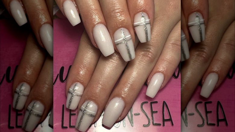 white nails with silver glitter crosses