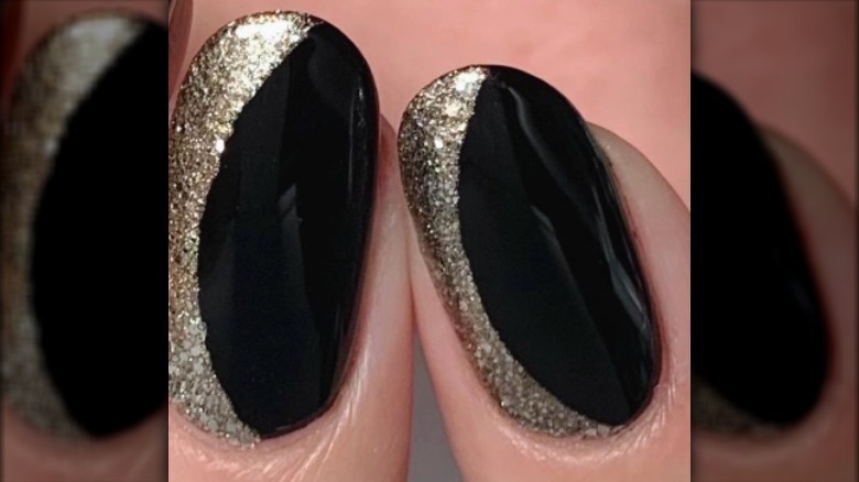 black nails with half gold glitter