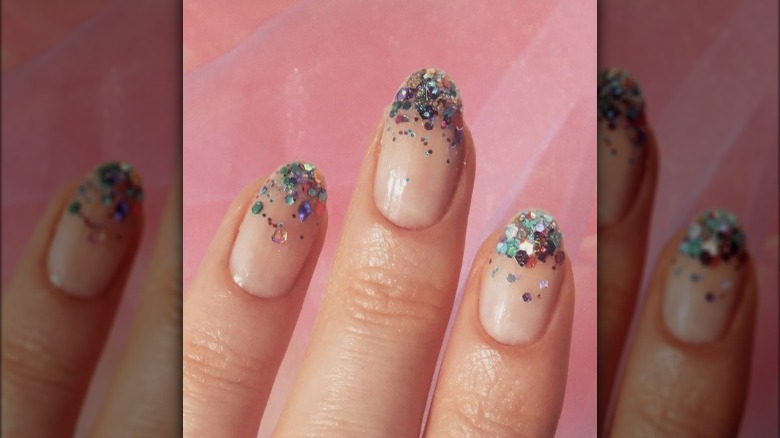 rainbow glitter on tips of clear nails