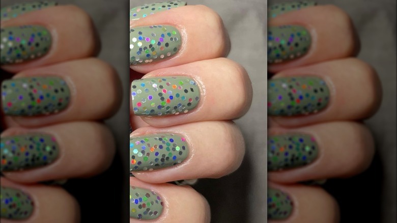 green nails with rainbow glitter