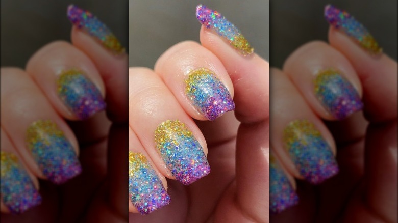 yellow, blue, and purple glitter nails