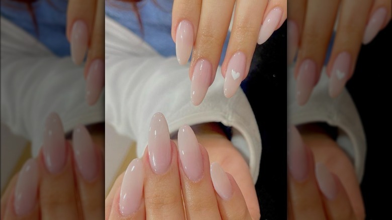 Nude manicure with heart accent 