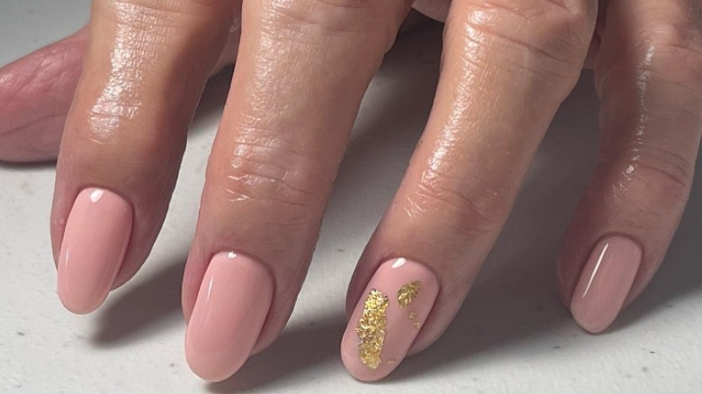 Gold speck on nude nail 