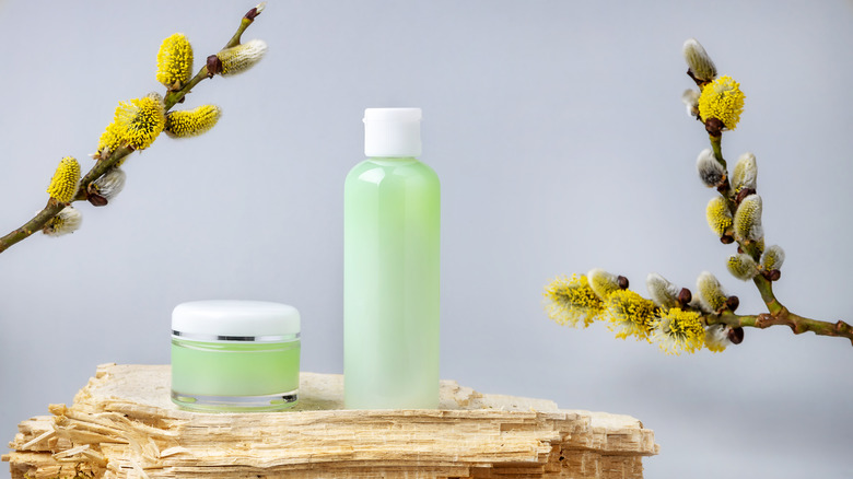 Skincare products with willow bark in background