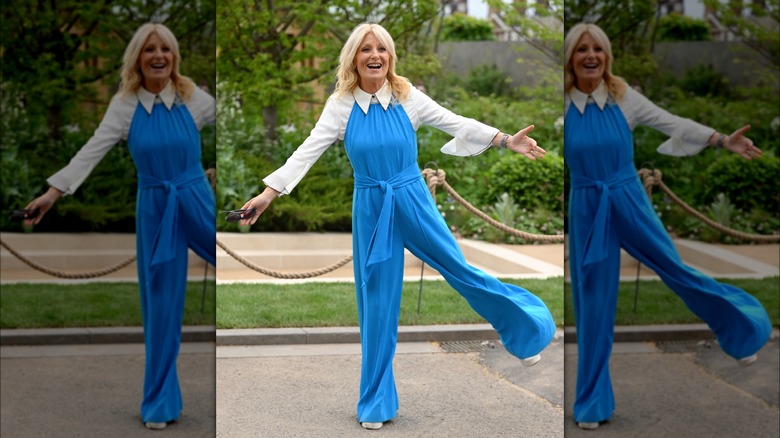 Gaby Roslin smiling in blue jumpsuit 