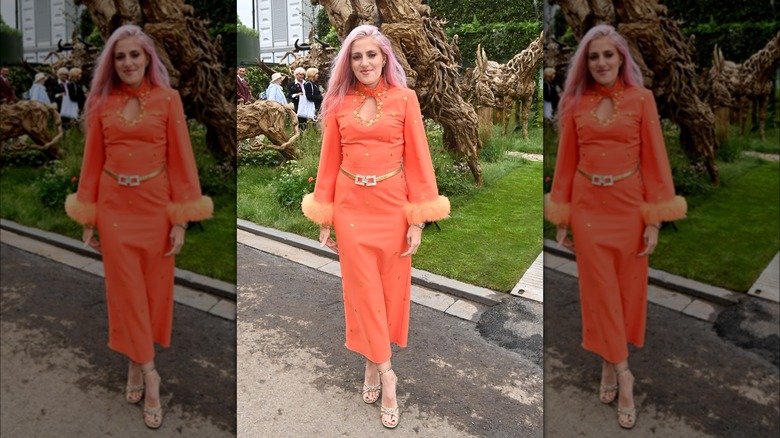 Sophie Tea smiles in orange dress 