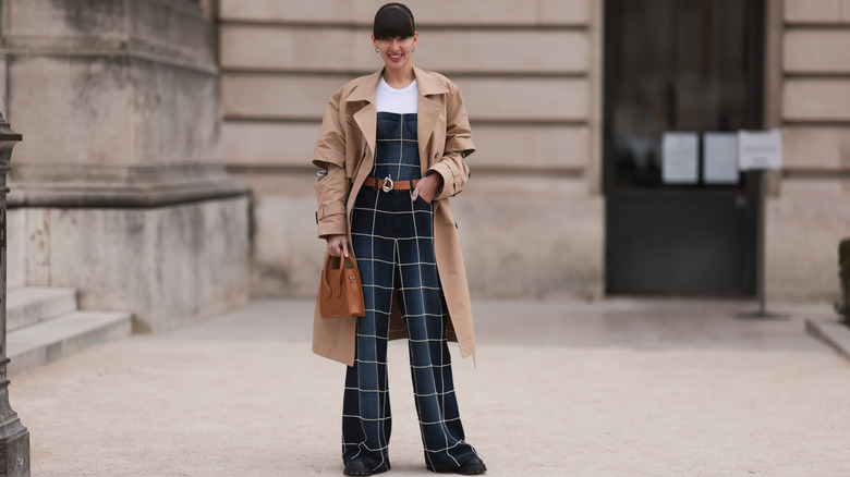 Dark denim jumpsuit and brown trenchcoat