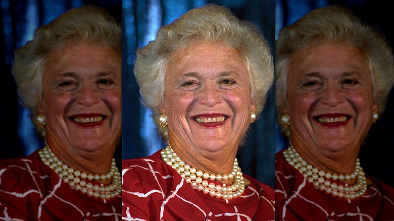 Barbara Bush wearing pearls and a red and white dress