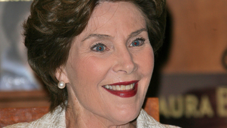 Laura Bush book signing pearl earring white suit