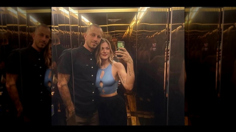 Frances Cobain and Riley Hawk smiling in an elevator