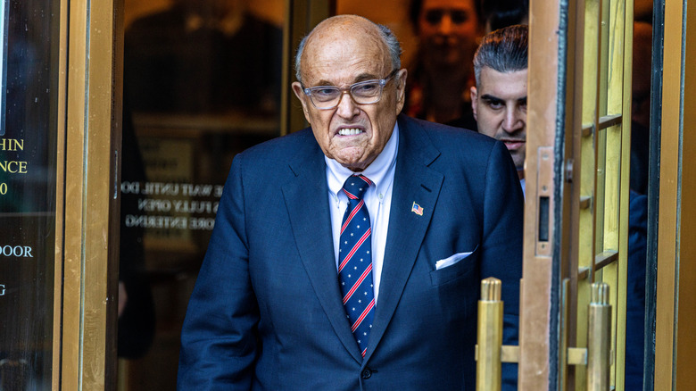 Rudy Giuliani walking out of a building